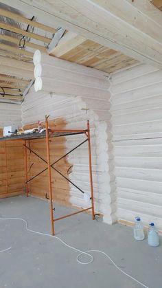 an unfinished room with scaffolding on the walls and wood beams in place for insulation