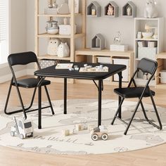 two children's chairs sitting at a black table