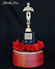 an award is displayed on top of a red box with roses around it and the words, faith & fortune