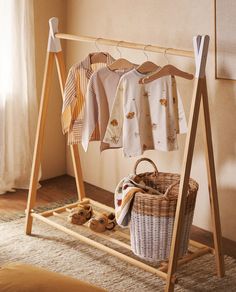 a clothes rack with baskets and clothing hanging on it