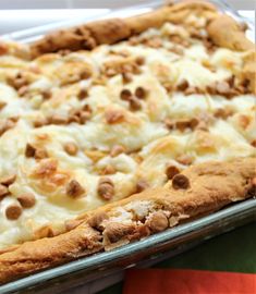 a pizza sitting on top of a metal pan covered in cheese and meat toppings