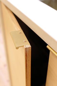 a close up of a wooden cabinet with a metal handle on the door and bottom