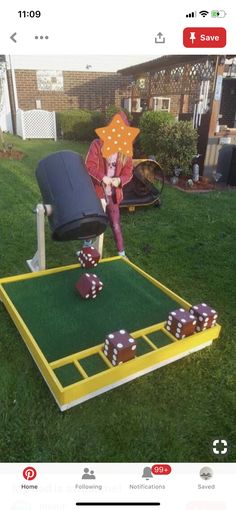 a person in a red jacket and some dices on a green lawn with a yellow frame