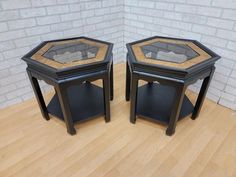 two tables with glass top sitting on a wooden floor