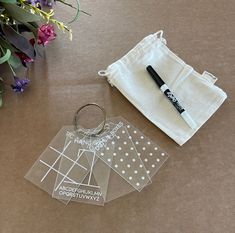 a pair of scissors sitting on top of a table next to some cloths and flowers