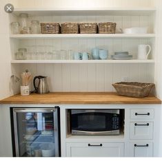 a kitchen with white cabinets and open shelves