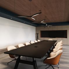 an empty conference room with chairs and a large table