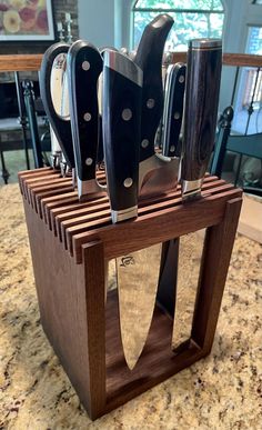 several knives are in a wooden holder on the counter