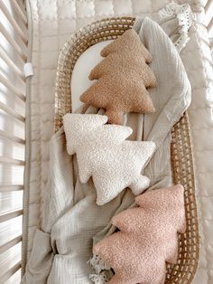 a basket filled with pillows next to a baby's crib and stuffed animals