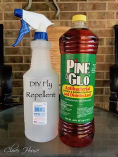 a bottle of pine glo sitting next to a plastic bottle of antibacterial and disinfectant