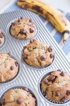 muffins with chocolate chips and a banana in the background