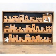 a wooden calendar with nativity figures on it