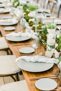 the table is set with plates and place settings for an elegant dinner or reception party