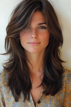 Woman with layered brown hair and freckles, wearing a patterned top, smiling lightly. Layered Hair With Face Frame, Medium Length Hair With Heavy Layers, Medium Length With Face Framing, Layered Hair Medium With Curtain Bangs, Middle Length Layered Haircut, Face Framing For Long Hair, Brown Medium Haircut, Layers And Face Framing Medium Hair, Medium Length Haircut For Thick Hair With Layers Bangs