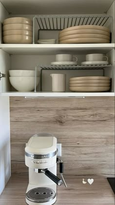 a coffee maker sitting on top of a wooden counter