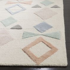 a white rug with various colored shapes on it