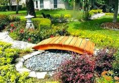 a wooden bench sitting in the middle of a garden