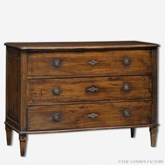 a wooden dresser with three drawers and two pulls on the bottom drawer, against a white background