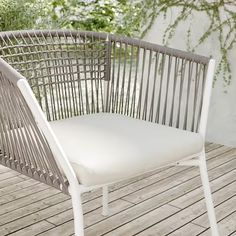 a white chair sitting on top of a wooden floor