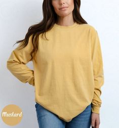 Blank Comfort Color Long Sleeve Shirt Long Sleeve Tee Wholesale Clothing Blank Shirt Long Sleeve Tshirt Women Long Sleeve Men Tee Long Shirt ✨ PRODUCT DESCRIPTION ✨ ∘ ∘ For an Oversized look, consider sizing up 1-2 above your normal size. ∘ ∘ UNISEX TSHIRT ∘ Relaxed fit ∘ Medium fabric ∘ 100% Preshrunk Cotton ∘ Garment-dyed fabric ∘ Double-needle topstitch seams for long-lasting ∘ ∘ Design colors may differ slightly from the final printed item due to the printing process and monitor calibration. ∘ ∘  📏 SIZE 📏 ∘ Adult Unisex sizing. We have a size chart on our listing photos ↑. ⏱️ SHIPPING & PRODUCTION TIME ⏱️ ∘ Please allow 1-5 business days for processing time. ∘ Shipping time is 3-5 business days. ✨ CARE INSTRUCTIONS ✨ ∘ Inside out, wash cold with a delicate cycle ∘ Hang Dry ∘ Do not u Yellow Crew Neck Top For Fall, Oversized Basic Solid Color Top, Basic Cotton Top For Fall, Trendy Long Sleeve Solid Color T-shirt, Basic Long Sleeve Plain Shirt, Basic Yellow Tops For Fall, Basic Yellow Fall Tops, Cotton Tops With Shirttail Hem For Fall, Basic Plain Tops For Fall