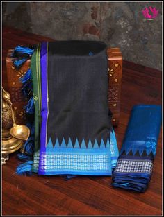 Berhampuri silk was introduced at Berhampur town in 14th century AD by the Mohuri Kings. It is known as ‘Silk City’ for its pure silk weaves. This Berhampuri silk saree is one of the traditional weaving and handloom heritage from Odisha. A vibrant Berhampuri pure silk saree in hues of black and blue with extended pallu - double anchal is just enough to steal any special occasion. The colorful pallu boasts traditional buttas. Handmade custom tassels adds grace to the saree. Blouse - Unstitched. F Festive Saree With Border For Rituals, Traditional Drape Saree With Border For Rituals, Rituals Saree With Border, Ceremonial Banarasi Silk Saree With Border, Traditional Saree With Border For Rituals, Black Handloom Saree For Ceremonial Occasions, Traditional Saree For Rituals With Border Detail, Ceremonial Black Handloom Saree, Traditional Wear With Border For Rituals And Festivals