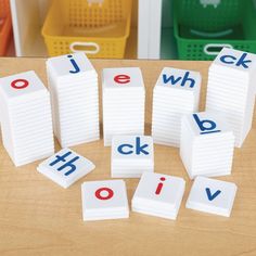 the letters are placed on top of each other in front of plastic bins and baskets