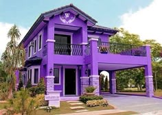 a purple house with an attached balcony and balconies on the second floor is shown