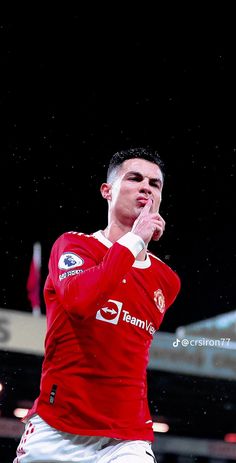 a man in red jersey holding a soccer ball