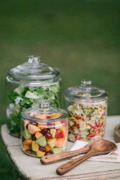 several glass containers filled with food on top of a table