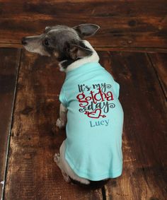 a small dog wearing a shirt that says it's my golden birthday lucky