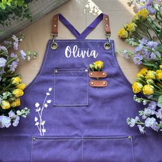 a purple apron with flowers and the name julia on it