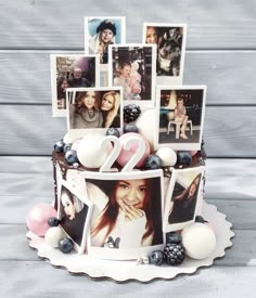 a cake decorated with photos and balloons