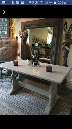 a white table sitting in front of a mirror