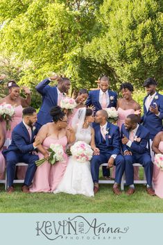 a group of people that are posing for a picture together on a bench in the grass