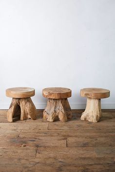 three wooden stools sitting on top of a hard wood floor