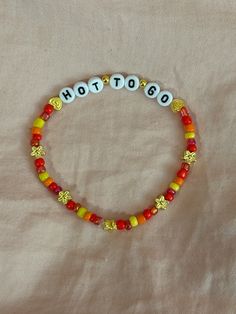 a beaded bracelet with the word hot to go written in small letters on it