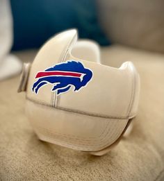 a pair of white shoes with the buffalo logo on them are sitting on a couch