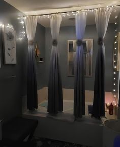 a bathroom with lights on the ceiling and curtains