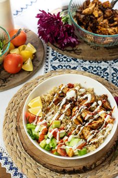 a bowl filled with food sitting on top of a table next to other plates and bowls