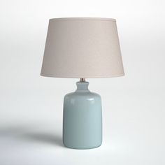 a light blue table lamp with a white shade on the base and a beige lampshade