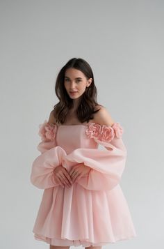 Introducing the Ariel Dress: a stunning short organza wedding dress that exudes elegance and charm. This dress features long, graceful sleeves and a boned bodice for a perfect fit, accentuated by delicate lacing at the back. The standout feature is the voluminous 3D flowers that adorn the dress, elevating it to a whole new level of sophistication. Perfect for the modern bride who wants to make a bold statement, the Ariel Dress combines timeless romance with contemporary flair, ensuring you look Elegant Organza Dress, Flower Sleeve Dress, Organza Flowers On Dress, Short Elegant Dresses, Dress With Organza Sleeves, Boning Dress, Dress With Flowers On It, Flower Dress Outfit, 3d Flower Dress