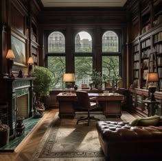 a library with a couch, chair and table in front of two large bookshelves