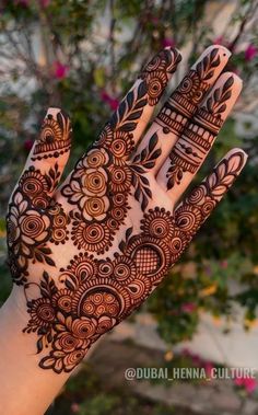 the hand is decorated with henna designs