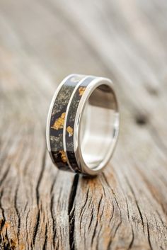 a wedding ring that has been made to look like it is painted with yellow flowers