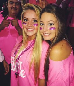 two girls in pink shirts with face paint