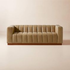 a brown couch sitting on top of a white floor