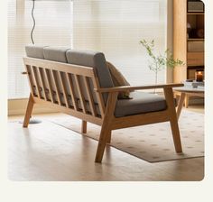 a wooden chair sitting on top of a hard wood floor next to a coffee table