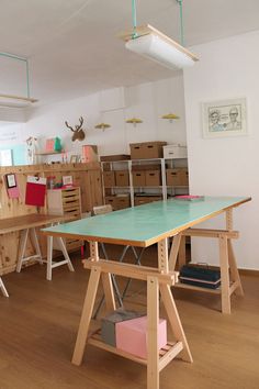 a room filled with lots of different types of crafting supplies on wooden tables and chairs