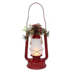 a red lantern with pine cones and berries on it's handle is lit up