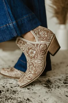 Elevate your style with our Western Moxie Hand-tooled Booties. Hand-crafted from rich white and chocolate-hued leather, these booties feature classic cowboy heels and stylish side slits for easy wear. The intricate hand-tooled design, inspired by desert blossoms, adds a touch of Western sophistication to any outfit. Pl Cowboy Fashion Womens, Boujee Cowgirl Outfits, Western Shoes Womens, Wedding Booties For Bride, Red Western Boots Outfit, Western Church Outfits Women, Cowgirl Booties Outfits, Women’s Boots, Cute Western Outfits Women